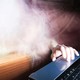 A phantom reaches a hand toward a laptop