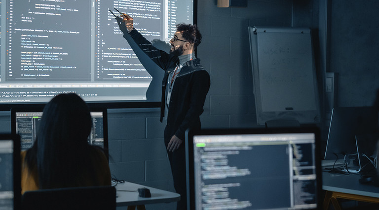 Instructor explaining programing to students